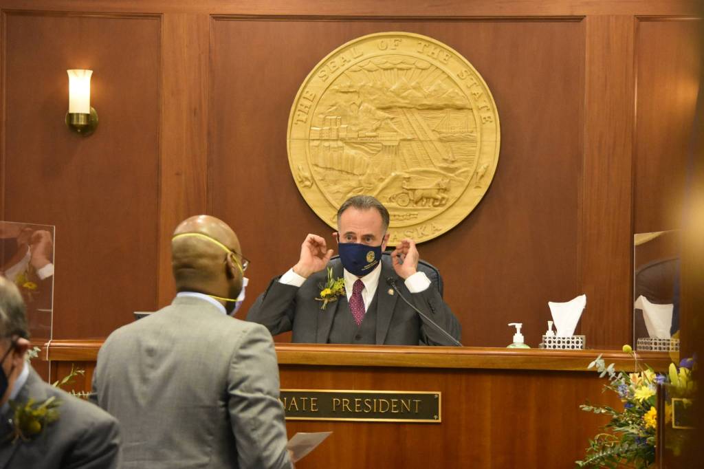 Newly elected Senate President Peter Micciche, R-Soldotna, speaks to Sen. David Wilson, R-Wasilla, on the first day of the 32nd Legislature on Tuesday, Jan. 19, 2020. (Peter Segall / Juneau Empire)