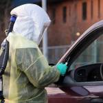 Sarah Palmer talks to a driver before administering a COVID-19 test in December 2020. On Tuesday, the City and Borough of Juneau reported an uptick in cases identified over the weekend that included Martin Luther King Jr. Day.  However, the community's COVID risk level remains at the moderate level, which was set last week after months with the community risk level set at high. (Ben Hohenstatt / Juneau Empire)