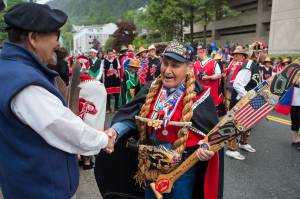 Marine veteran Marvin Kadake, right, of the Keex Kwaan Dancers (People of Kake) shakes hands with Ed Kunz during the Grand Entrance for Celebration 2018 along Willoughby Avenue on Wednesday, June 6, 2018. The 2020 version of the every-other-year event had been tentatively scheduled for this summer, but those plans have been canceled, organizers announced. (Michael Penn / Juneau Empire File)