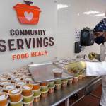 Chef Jermaine Wall stacks containers of soups at Community Servings, which prepares and delivers scratch-made, medically tailored meals to individuals & families living with critical & chronic illnesses, Tuesday, Jan. 12, 2021, in the Jamaica Plain neighborhood of Boston. Food is a growing focus for insurers as they look to improve the health of the people they cover and cut costs. Insurers first started covering Community Servings meals about five years ago, and CEO David Waters says they now cover close to 40%. (AP Photo / Charles Krupa)