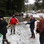 Helpers have an afteraction Juneau Raptor Center manager Kathy Benner, far left, after an attempt to capture a trumpeter swan with an injured wing at Auke Lake on Jan. 28, 2021. (Michael S. Lockett / Juneau Empire)