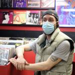 Nano Brooks talks in front of racks of records inside Hi-Fi Senpai on Saturday, Jan. 30. The shop includes vintage audio equipment and old forms of physical media. (Ben Hohenstatt / Juneau Empire)