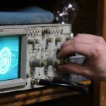 Nano Brooks twists the dial of an oscilloscope  a device that uses electrical signals from sound waves to create images while the oscilloscope shows an image that looks a lot like an exploding Death Star from Star Wars. (Ben Hohenstatt / Juneau Empire)