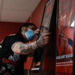 Ben Hohenstatt / Juneau Empire 
Anthony Thingvall (above) hangs a signed AC/DC poster inside Hi-Fi Senpai, a new record and hi-fi equipment shop in the Mendenhall Valley on Saturday. Top, Nano Brooks twists the dial of an oscilloscope  a device that uses electrical signals from sound waves to create images while the oscilloscope shows an image that looks a lot like an exploding Death Star from Star Wars.