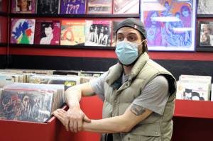 Nano Brooks talks in front of racks of records inside Hi-Fi Senpai on Saturday, Jan. 30. The shop includes vintage audio equipment and old forms of physical media. (Ben Hohenstatt / Juneau Empire)