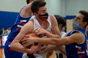 Juneau-Douglas' Garrett Bryant (24) is fouled by Sitka's Stephen Harmon on a rebound Thursday night at Sitka High. (Photo James Poulson)