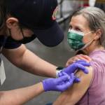 Wendy Wallers administers the coronavirus vaccine to Christina MacDougall during a clinic at Centennial Hall on Feb. 11, 2021. The City and Borough of Juneau lowered the risk level for the coronavirus to Level 1 on Feb. 17, the lowest since the system was put in place. (Michael S. Lockett / Juneau Empire)