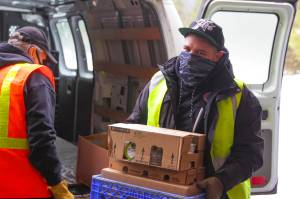 Thomas Moreno, Southeast Alaska Food Bank employee, unloads food at the food bank on Feb. 18, 2021. (Michael S. Lockett / Juneau Empire)