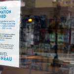 A sign posted by Travel Juneau notes the pamphlet-filled visitor's center kiosk is closed because of the pandemic. The center, located near the downtown library, opened in May 2019 during Infrastructure Week. (Ben Hohenstatt / Juneau Empire File)