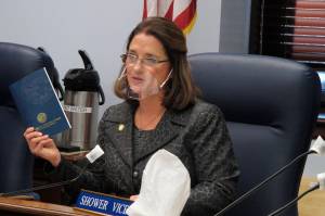 Alaska state Sen. Lora Reinbold, an Eagle River Republican, holds a copy of the Alaska Constitution during a committee hearing on Wednesday, Jan. 27, 2021, in Juneau, Alaska. Gov. Mike Dunleavy, a Republican, sent Reinbold a letter on Feb. 18, 2021, saying she has used her position to misrepresent the states COVID-19 response. Reinbold said the letter was full of baseless accusations and complaints. (AP Photo / Becky Bohrer)