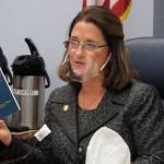 Alaska state Sen. Lora Reinbold, an Eagle River Republican, holds a copy of the Alaska Constitution during a committee hearing in Juneau, Alaska. Reinbold has been a vocal critic, along with other lawmakers, of Gov. Mike Dunleavys disaster declarations while the Legislature was not in session. She has used her committee to amplify voices of those who question the effectiveness of masks and the usefulness of the governments emergency response. In a scathing letter that included references to her Facebook posts, Dunleavy accused Reinbold of misrepresenting the states COVID-19 response and deceiving the public. The misinformation must end, the governor wrote. (AP Photo / Becky Bohrer)