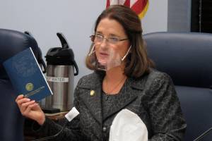 Alaska state Sen. Lora Reinbold, an Eagle River Republican, holds a copy of the Alaska Constitution during a committee hearing in Juneau, Alaska. Reinbold has been a vocal critic, along with other lawmakers, of Gov. Mike Dunleavys disaster declarations while the Legislature was not in session. She has used her committee to amplify voices of those who question the effectiveness of masks and the usefulness of the governments emergency response. In a scathing letter that included references to her Facebook posts, Dunleavy accused Reinbold of misrepresenting the states COVID-19 response and deceiving the public. The misinformation must end, the governor wrote. (AP Photo / Becky Bohrer)