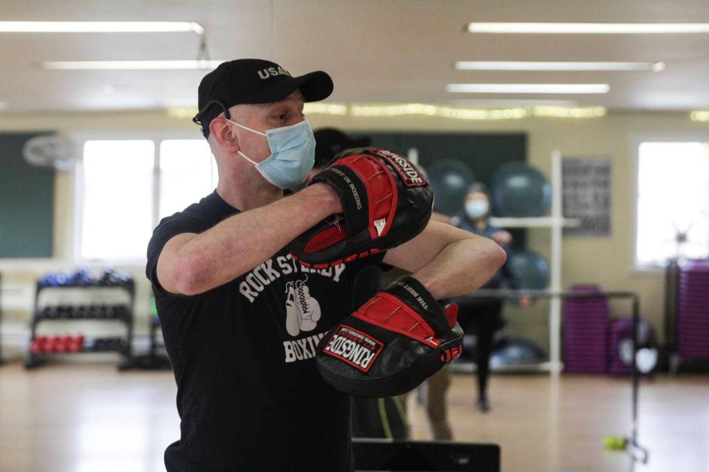 Alec Nevalainen leads a boxing class designed to help fight back against the symptoms Parkinsons disease through a specific regimen at Pavitt Health and Fitness on March. 2, 2021. (Michael S. Lockett / Juneau Empire)