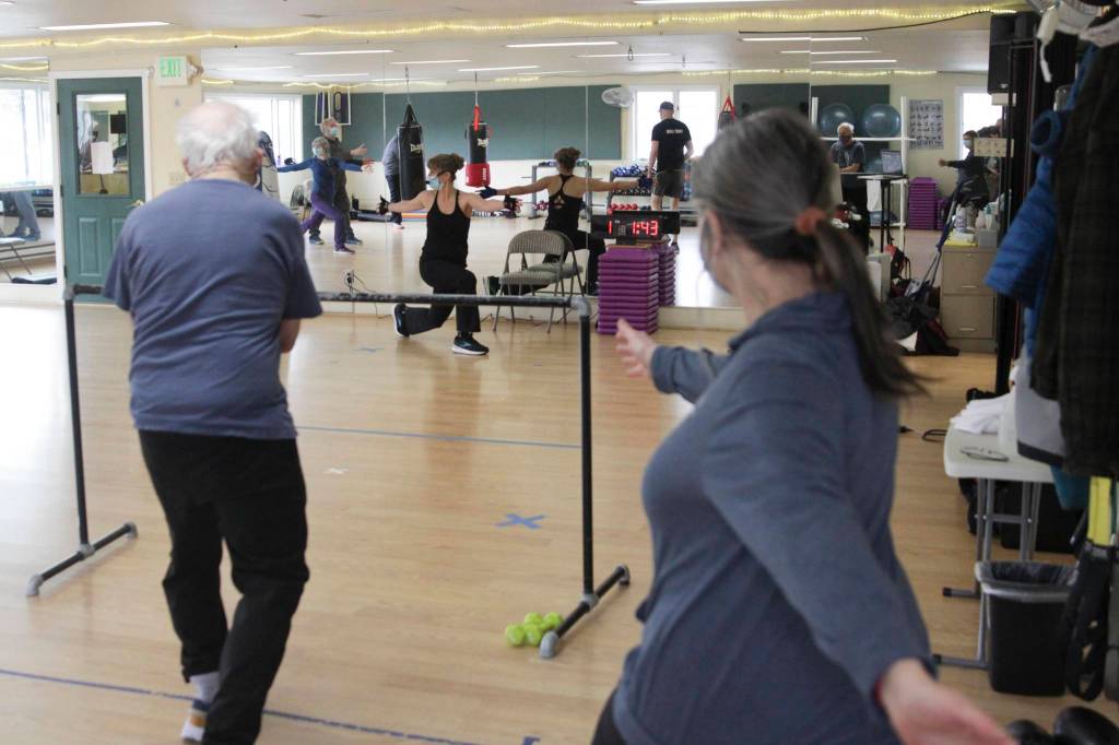 Janet Valentour, center, leads a boxing class designed to help fight back against the symptoms Parkinsons disease through a specific regimen at Pavitt Health and Fitness on March. 2, 2021. (Michael S. Lockett / Juneau Empire)