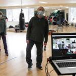 Members of the Rock Steady boxing class, a class designed to help fight back against the symptoms Parkinsons disease through a specific regimen, participate with members on Zoom in a cool-down at Pavitt Health and Fitness on March. 2, 2021. (Michael S. Lockett / Juneau Empire)