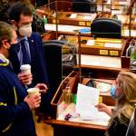 From left to right: Alaska state Reps. Chris Tuck, D-Anchorage, Zack Fields, D-Anchorage, and Sara Rasmussen, R-Anchorage, speak on the Alaska House floor on Friday, March 5, 2021. The House passed a Sense of the House on Friday, condemning as inappropriate and objectifying comments Fields had made toward Rasmussen last month. (Peter Segall / Juneau Empire)