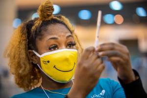 Medical Assistant Keona Shepard holds up the Johnson & Johnson COVID-19 vaccine as she prepares to administer it at the New Orleans Ernest N. Morial Convention Center during the mass coronavirus vaccination in New Orleans, in this Thursday, March 4, 2021, file photo. (Chris Granger / The Advocate)