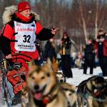 Aliy Zirkle, of Two Rivers, greets fans as she passes by at the Iditarod Sled Dog Race start at Deshka Landing in Willow, Alaska, Sunday, March 7, 2021. (Marc Lester / Anchorage Daily News)