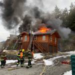 Capital City Fire/Rescue firefighters seek to extinguish a house fire near Point Lena on March 10, 2021. (Courtesy photo / CCFR)