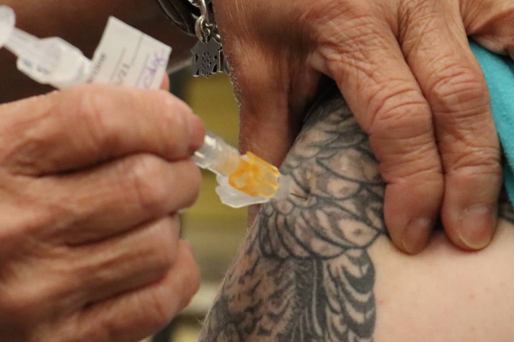 Department of Veterans Affairs nurse Dale Cotton administers a dose of Johnson & Johnson COVID-19 vaccine during a clinic at Coast Guard Station Juneau on March 13, 2021. (Ben Hohenstatt / Juneau Empire)