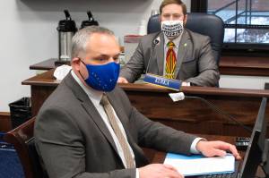 Alaska Attorney General Treg Taylor, foreground, appears before the House Judiciary Committee for a confirmation hearing on Monday, March 15, 2021, in Juneau, Alaska. Republican Rep. Christopher Kurka, a committee member, is seen in the background. (AP Photo / Becky Bohrer)