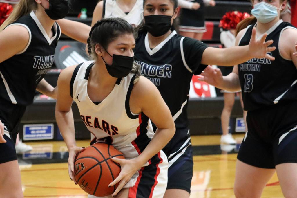 Juneau-Douglas Trinity Jackson (12) looks to make a pass during a close game against Thunder Mountain. (Ben Hohenstatt / Juneau Empire)