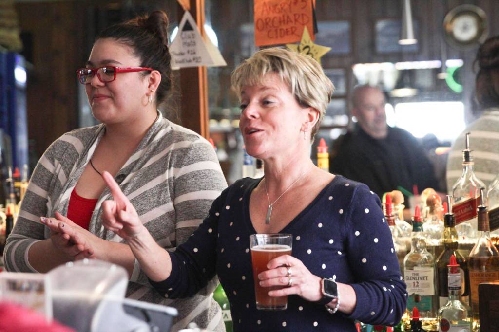 photos by Michael S. Lockett | Juneau Empire
Triangle Club owner Leeann Thomas, right, and bartender Sam Sims, toast the bar at last call before an indefinite closure due to coronavirus prevention measure, March 18, 2020.