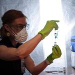 Bartlett Regional Hospital infection preventionist Charlee Gribbon prepares vaccines during a clinic at Centennial Hall on Feb. 11, 2021. (Michael S. Lockett / Juneau Empire)