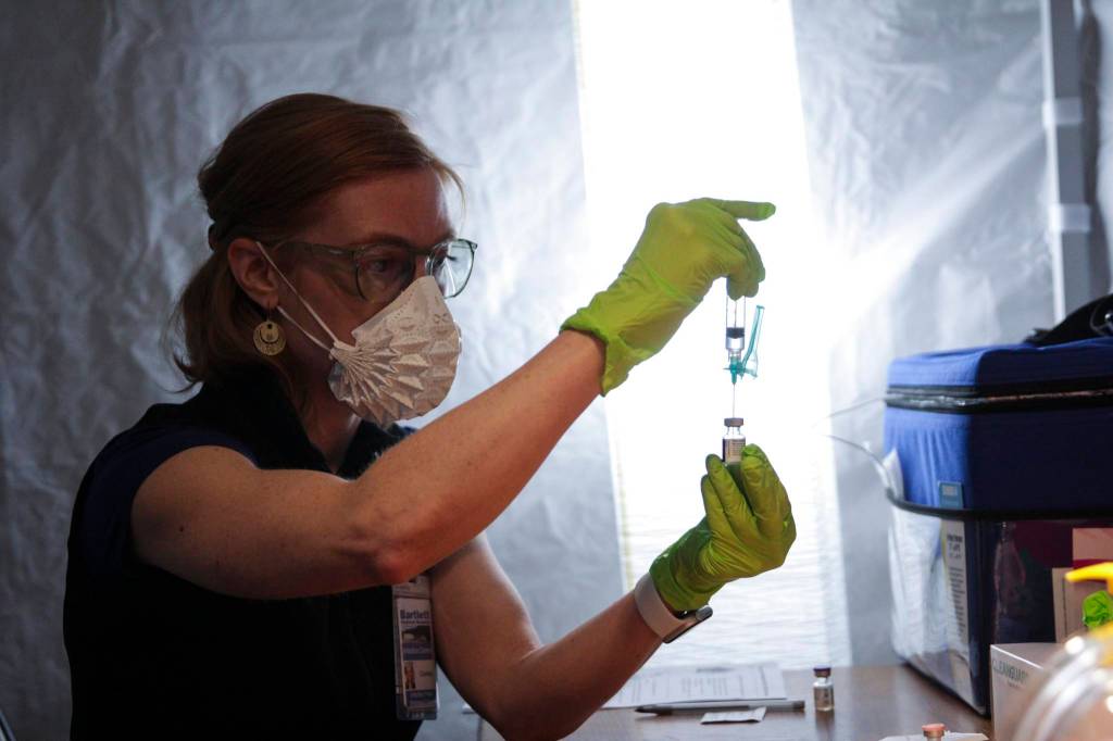 Bartlett Regional Hospital infection preventionist Charlee Gribbon prepares vaccines during a clinic at Centennial Hall on Feb. 11, 2021. (Michael S. Lockett / Juneau Empire)