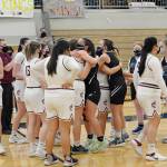 Thunder Mountain Falcons congratulate Ketchikan High School players following a 51-29 loss to Kayhi in the girls varsity Region V basketball championship at Clarke Cochrane Gymnasium on Saturday, March 20, 2021. (Dustin Safranek / Ketchikan Daily News)