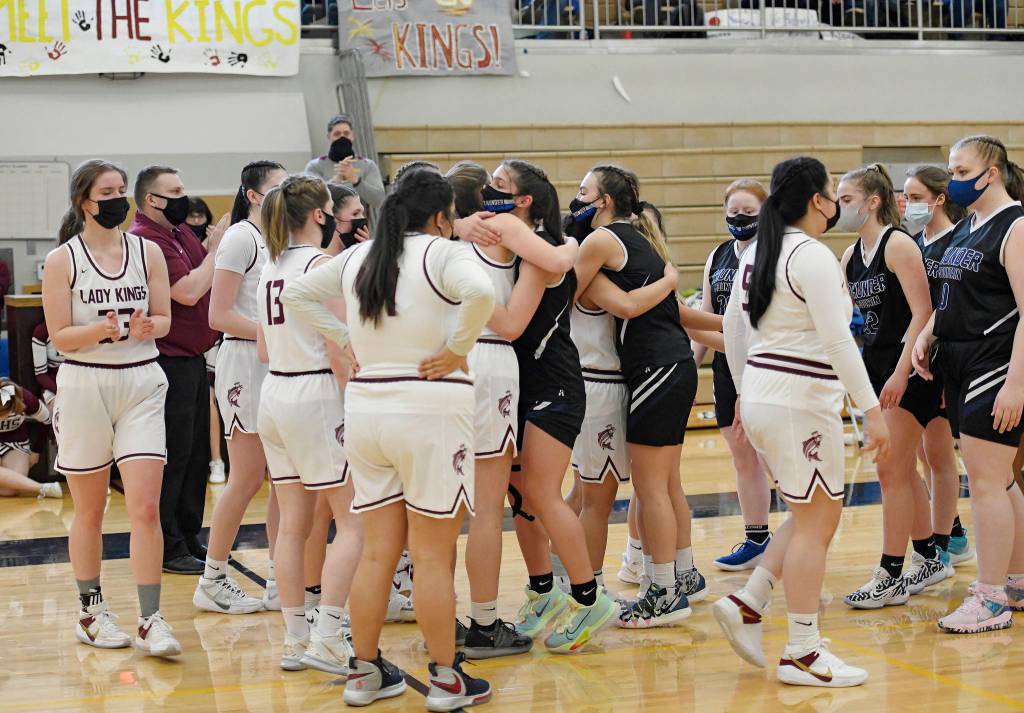 Thunder Mountain Falcons congratulate Ketchikan High School players following a 51-29 loss to Kayhi in the girls varsity Region V basketball championship at Clarke Cochrane Gymnasium on Saturday, March 20, 2021. (Dustin Safranek / Ketchikan Daily News)