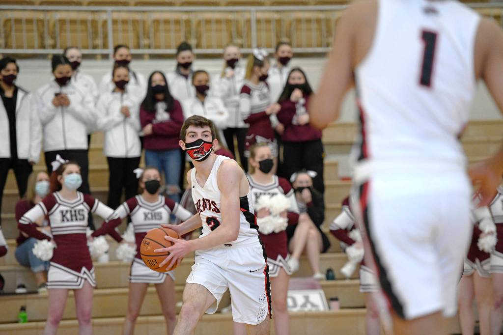 Juneau-Douglas High School Yadaa.at Kalé player Tlas Carney looks to pass to Lope Elizarde during the first half in the boys varsity Region V basketball championship against Ketchikan High School at Clarke Cochrane Gymnasium on Saturday, March 20, 2021. (Dustin Safranek / Ketchikan Daily News)