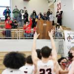 Juneau-Douglas High School: Yadaa.at Kalé player Cooper Kriegmont holds the 2021 Region V championship plaque up for Juneau spectators following a 87-68 win over Ketchikan in the boys varsity Region V basketball championship at Clarke Cochrane Gymnasium on Saturday, March 20, 2021. (Dustin Safranek / Ketchikan Daily News)