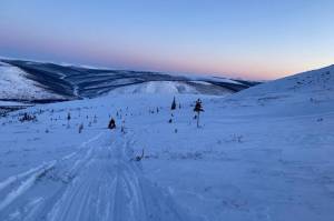 The author and Fairbanks resident Harrison Gottschling return to the truck after taking a caribou in the interior over spring break last week. (Jeff Lund / For the Juneau Empire)