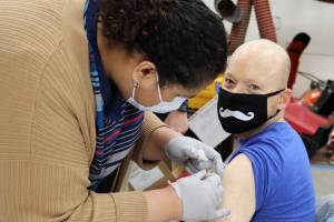 A panel of state and local experts answered questions and encouraged COVID-19 vaccinations during a moderated online discussion Wednesday evening. Dr. Anne Zink, Alaska’s Chief Medical Officer, encouraged all eligible Alaskans to get vaccinated as soon as possible to end the pandemic. Here, department of Veterans Affairs nurse Regina McComber applies a bandage to David Summers’ arm on the morning of March 13, 2021. Summers was among the veterans who were vaccinated at a VA clinic in Juneau. (Ben Hohenstatt/Juneau Empire)