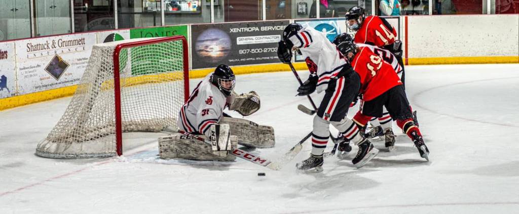 Juneau-Douglas High School: Yadaa.at Kalé Crimson Bears goalie Dawson Hickok, in goal, will be one of three seniors to graduate this spring after a season of no games for the hockey team. (Courtesy photo / Steve Quinn)