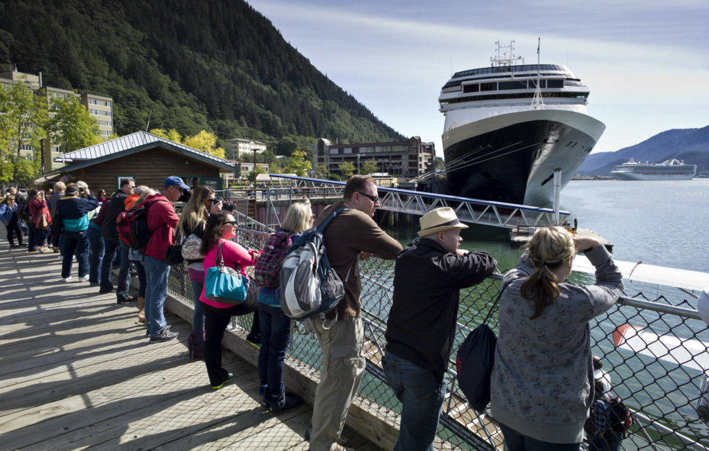 Tourists view Juneaus downtown harbor in August 2015. (Michael Penn / Juneau Empire File)