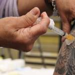 Department of Veterans Affairs nurse Dale Cotton administers a dose of Johnson & Johnson COVID-19 vaccine. (Ben Hohenstatt / Juneau Empire)