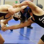 Blaze Darbonne ties up with a wrestler from Ketchikan during a tournament held at Thunder Mountain High School on Friday, April 2. (Ben Hohenstatt / Juneau Empire)