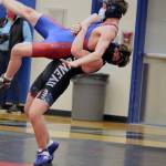Josh Quintal takes a wrestler from Sitka to the mats during a wrestling tournament at Thunder Mountain High School. (Ben Hohenstatt / Juneau Empire)
