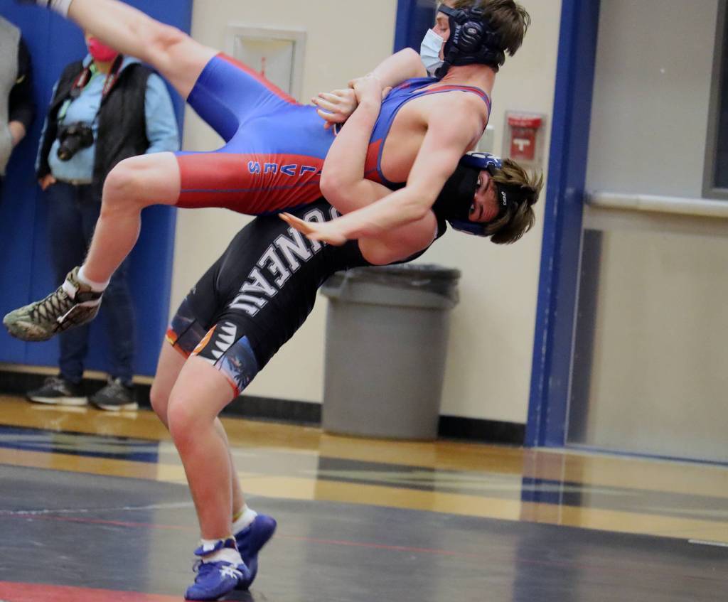 Josh Quintal takes a wrestler from Sitka to the mats during a wrestling tournament at Thunder Mountain High School. (Ben Hohenstatt / Juneau Empire)