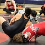 A referee checks to see if Jamal Johnson has pinned his opponent from Wrangell High School during a wrestling tournament at Thunder Mountain High School. Johnson eventually won the match via pin with a different hold. Johnson won all of his matches on Friday and Saturday. (Ben Hohenstatt / Juneau Empire)
