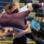 Carson Cummins hoists his opponent from Ketchikan High School before taking him to the mat during a tournament at Thunder Mountain High School on Friday, April 3. (Ben Hohenstatt / Juneau Empire).
