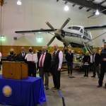 State lawmakers including Juneau Democrats Sen. Jesse Kiehl and Rep. Andi Story, pose with a copy of a joint resolution urging federal action to allow cruising to return to Alaska this summer. Gov. Mike Dunleavy stands to the left and Juneau Mayor Beth Weldon is in the left background in the hangar of Wings Airways in Juneau on Friday, April 9, 2021. (Peter Segall / Juneau Empire)