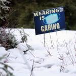 A sign along Montana Creek Road encourages Juneau residents to wear face masks in public settings on Dec. 29. The (Ben Hohenstatt / Juneau Empire File)