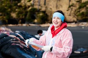 Dr. Lauren Wild smiles during a recent whale necropsy near Sitka. Wild is a UAS researcher and fisheries professor, and yes, you can call her Dr. Wild. (Courtesy Photo / Bethany Sonsini Goodrich and Lione Clare, operating under NOAA Stranding Agreement MMHSRP #18786-04)