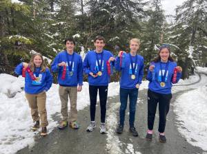 Thanks to COVID-19 vaccines, the members of the New Squids on the Dock were able to gather and look over the hardware they won in the Tsunami Bowl, a regional ocean science academic competition. The team from Juneau-Douglas High School: Yadaa.at Kalé is now busy preparing for the upcoming national competition. From left to right, team members include Elin Antaya, Jack Marx, team captain Tias Carney, Adrian Whitney and Addy Mallot. (Courtesy photo/Shannon Easterly)