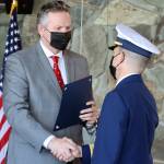 Gov. Mike Dunleavy shakes hands with Rear Adm. Matthew T. Bell Jr. during a Change of Command and retirement ceremony Friday, April 23, 2021 at Mendenhall Glacier Visitor Center. (Ben Hohenstatt / Juneau Empire)