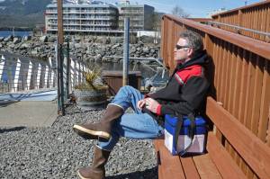 Gov. Mike Dunleavy sits beside a case containing COVID-19 vaccine doses as he waits near a floatplane dock on Thursday, April 22, 2021, in Ketchikan, Alaska. State health officials have said Alaska has an ample supply of COVID-19 vaccines, and Dunleavy, who flew from Ketchikan to Hyder, Alaska, said he wanted to offer vaccines not only to residents of Hyder but also to Canadians across the border from Hyder in Stewart, British Columbia. (AP Photo/Becky Bohrer)
