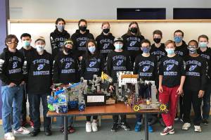 Members of Thunder Mountain High School's four robotics teams stand with four robots. (Courtesy Photo / Carol May)